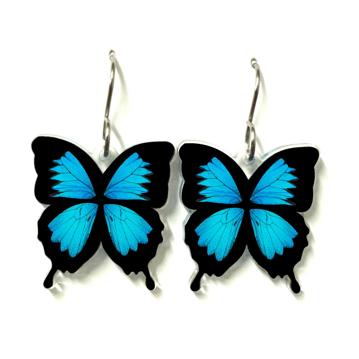 Pair of vibrant blue Ulysses Butterfly drop earrings made from recycled plastic with surgical steel hooks on a plain white background.