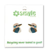 A pair of kookaboo bird stud earrings on a white backing card. The backing card features the green 'smyle designs' logo at the top and the slogan 'Recycling never looked so good!' at the bottom.