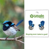 Bird on a branch with Smyle Designs earrings featuring a similar design.